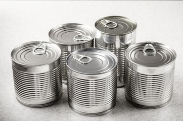 Set of various canned foods in tin cans on kitchen table, non-perishable, long shelf life food for...