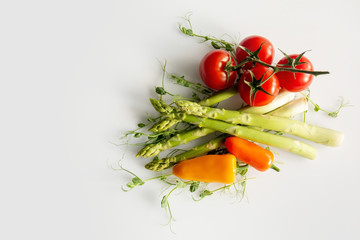 Fresh asparagus, tomatoes, bell papers isolated on a white background.