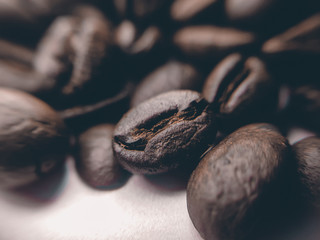 close up of Black coffee beans with a natural bitter taste, with blurry background
