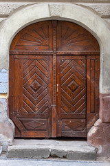 Vintage brown wooden door of antique house in an old European city.