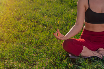 Hands closeup namaste. young Caucasian girl practices yoga meditation in the fresh air. The concept of peace of mind.