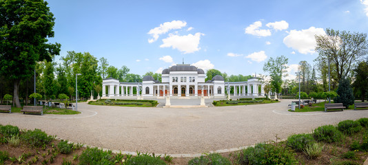 Panoramic ultrawide distorted image of old baroque casino building in Central Park of Cluj-Napoca, Romania