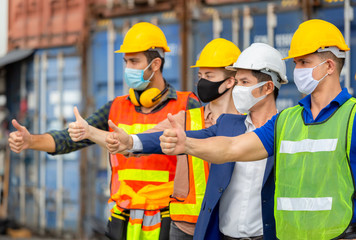 Success Teamwork Concept, Business people engineer and worker team wearing protection face mask against coronavirus with giving thumbs up as sign of success