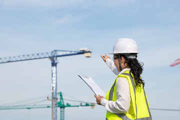 Asian engineer working at site of a large building project,Thailand people,Work overtime at construction site