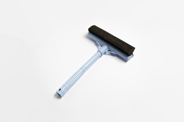 Window glass squeegee isolates on white background. Window cleaning brush. High-resolution photo.