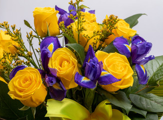 beautiful floristic bouquet of blue irises and yellow roses