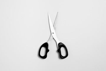 Black scissors isolated white background with a clipping path, close up open scissors object. Top view.High-resolution photo.