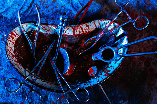 Dirty bloodstained medical utensils and tools on a gloomy table. The concept of illegal abortions at home.