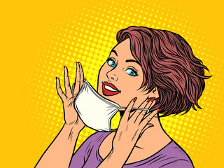 woman puts on a medical mask
