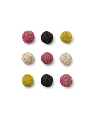 Colorful vegan candies energy balls on isolated white background