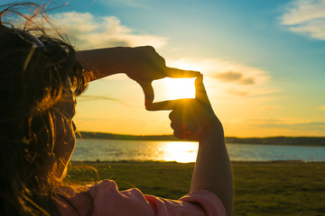 Future planning, business concept, close up of woman hands making frame gesture with sunrise...