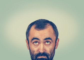 Headshot confused man thinking looking up