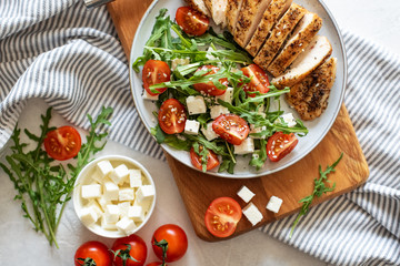 Close-up on a salad with chicken and tomato