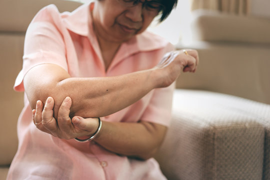 Asian Elderly People Woman Has Elbow Pain.