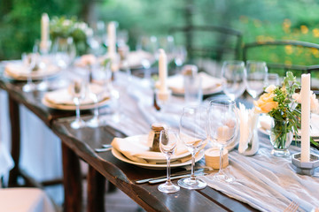 Range of served venues for a festive open-air welcome dinner at the wedding with personalized gifts for guests at each of them