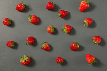 Fresh delicious natural sweet strawberries on grey background. Close up view.