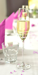 Close-up of glass of sparkling wine on decorated table at wedding