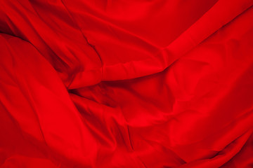 Obraz premium Close-up of folds of red fabric. Rolled up rag.