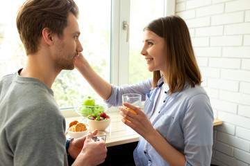 Young smiling couple enjoying tea at home