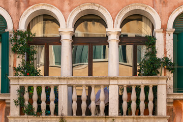Traditional Venetian window  style with balcony and reflections