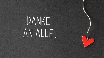 Danke an alle - Thank you all in German language with handmade small paper hearts