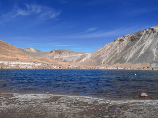 Panoramic view of the Laguna de la Luna, in the crater of the old Nevado de Toluca volcano, located at about 4600 meters above sea level. Lakes and mountain with blue sky.