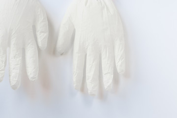 Medical disposable a pair of white latex gloves lie on a white background.