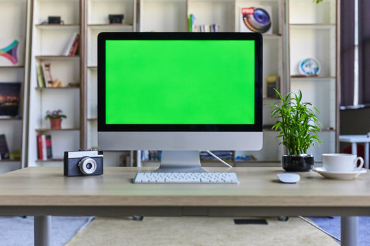 Computer desktop with mock-up green screen white background in office and  Lovely plant in black pot Stock Photo | Adobe Stock