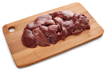 Raw chicken livers on  on a wooden cutting board on white background.