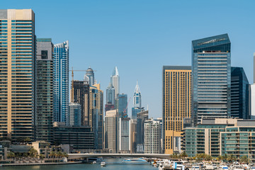 Obraz na płótnie Canvas Panoramic view of Dubai skyscrapers in UAE. Dubai Marina prestigious residential area of Dubai close to the sea. Concept of financial success and luxury lifestyle.