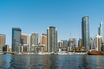 Fototapeta na wymiar Panoramic view of Dubai skyscrapers in UAE. Dubai Marina prestigious residential area of Dubai close to the sea. Concept of financial success and luxury lifestyle.