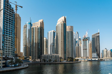 Panoramic view of Dubai skyscrapers in UAE. Dubai Marina prestigious residential area of Dubai close to the sea. Concept of financial success and luxury lifestyle.