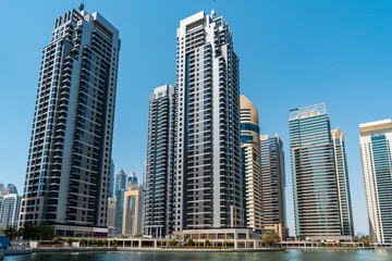 Fototapeta na wymiar Panoramic view of Dubai skyscrapers in UAE. Dubai Marina prestigious residential area of Dubai close to the sea. Concept of financial success and luxury lifestyle.