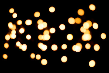 Yellow blurry lights on a black background, bokeh.