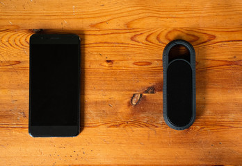  The bluetooth mp3 speaker is connected to a mobile phone. .Black smartphone with black mp3 dimamic...