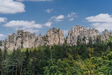 Fototapeta na wymiar Beautiful view of the rocky ridge of Suche skaly (Dry Rocks), in Cuech paradise (Cesky raj). Fantastic sharp rock wall and sandstone formation of Suche skaly, Czech republic.