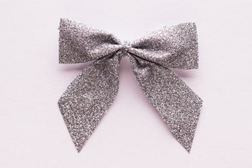 Silver bow on a white paper with clipping path