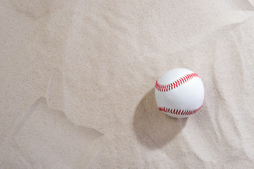 Fototapeta na wymiar Baseball On Sand At Beach. Team sport concept