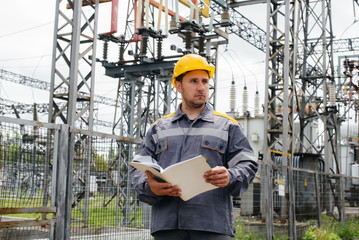 The energy engineer inspects the equipment of the substation. Power engineering. Industry