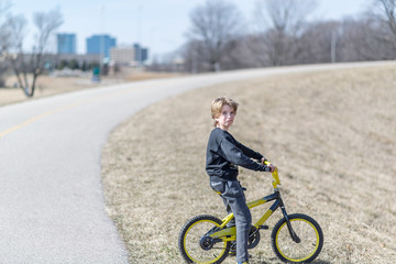 
Portrait of a child on a bicycle on  sunny day in a park
