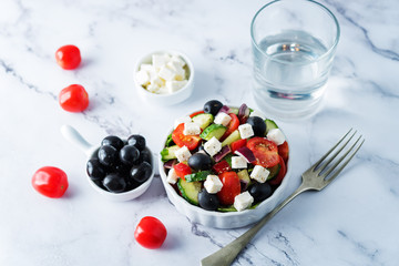 Naklejka na ściany i meble Greek Salad with ingredients in a white bowl