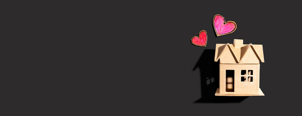 Cardboard house with heart crayon drawings - flatlay