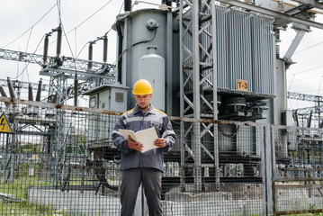 The energy engineer inspects the equipment of the substation. Power engineering. Industry