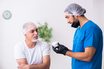 Old man visiting male doctor for plastic surgery