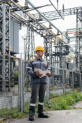 The energy engineer inspects the equipment of the substation. Power engineering. Industry