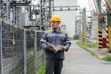 The energy engineer inspects the equipment of the substation. Power engineering. Industry