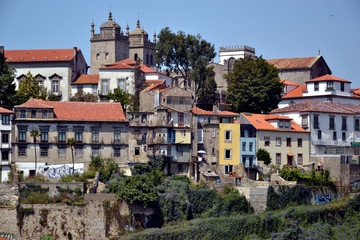 Fototapeta na wymiar Porto, Portugal - August 20, 2015: Cityscape of Porto, near the Douro river. You can see the two bell towers of the city's cathedral (Sé de Porto)