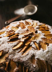 Closeup view of home baked rustic natural apple pie on dark brown wooden table