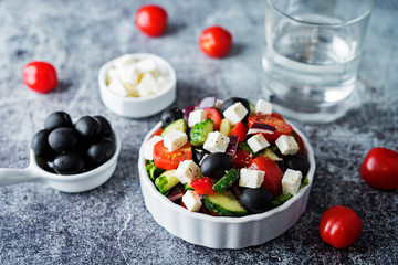 Greek Salad with ingredients in a white bowl