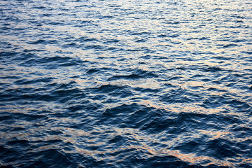 Close up of river water surface with slight ripples at the evening